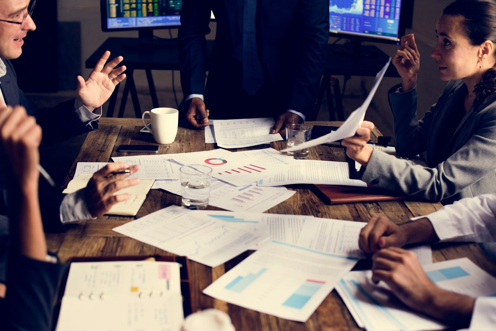 A team reviewing charts and business data around a table